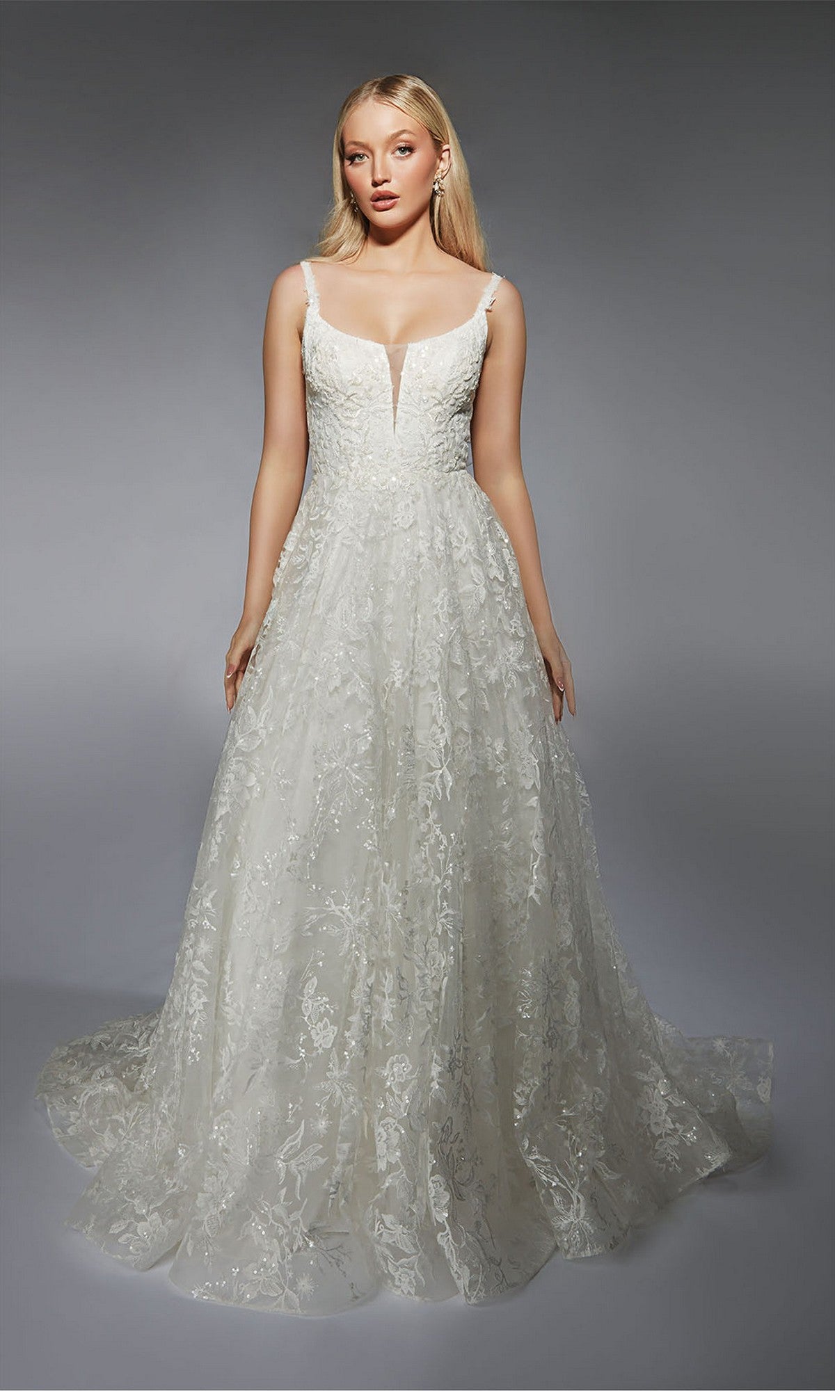 A woman models the Alyce 7123, a sleeveless floor-length white lace formal dress with a deep V neckline and elegant A-line skirt, standing against a plain gray background.